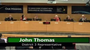 School Board Member John Thomas gave a speech and made a motion to reconsider Mrs Calhoun’s teaching application. The mo...