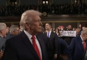 Rep. Al Green was ejected after protesting Trump’s speech while holding a sign that said “BLACK PEOPLE ARENT APES” and c...